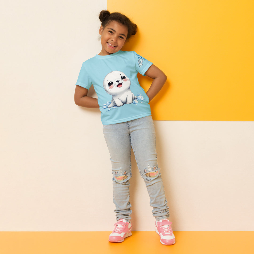 Frosty Seal Girls T-shirt, light sky blue background with a white baby seal surrounded by ice cubes on the front, blue and white snowflakes on the left sleeve, and an icy blue iceberg on the back, relaxed front pose on model