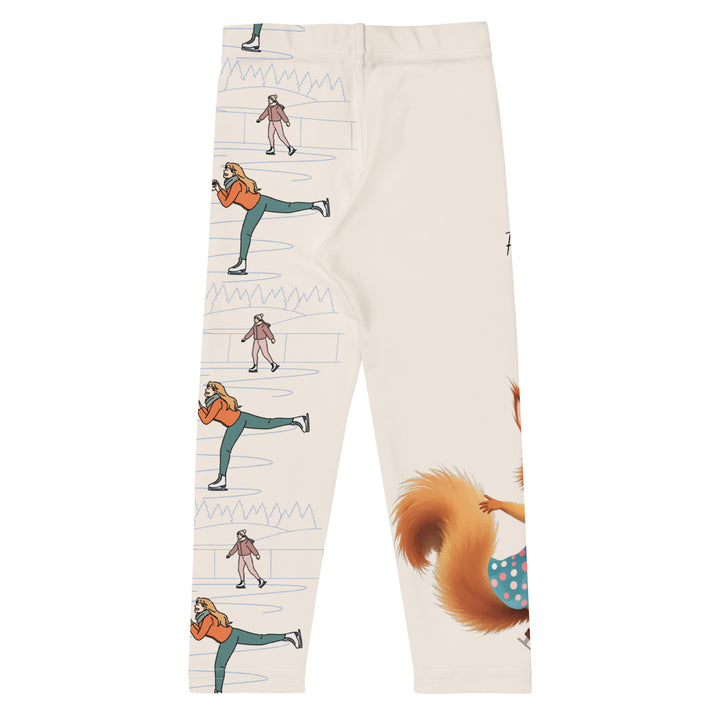 Frosty Twirl Squirrel Girls Leggings, beige background with a brown squirrel ice skating in a blue polka dot dress on one leg, ice trail lines, mountains, and small ice skaters along the other leg, in blue, brown, and orange tones, back view