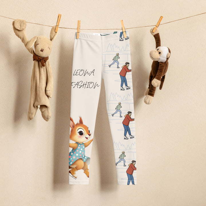 Frosty Twirl Squirrel Girls Leggings, beige background with a brown squirrel ice skating in a blue polka dot dress on one leg, ice trail lines, mountains, and small ice skaters along the other leg, in blue, brown, and orange tones, front view on hanger-with a visible 'Leona Fashion' text on the design