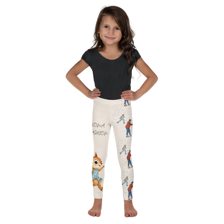 Frosty Twirl Squirrel Girls Leggings, beige background with a brown squirrel ice skating in a blue polka dot dress on one leg, ice trail lines, mountains, and small ice skaters along the other leg, in blue, brown, and orange tones, front view on model-with a visible 'Leona Fashion' text on the design