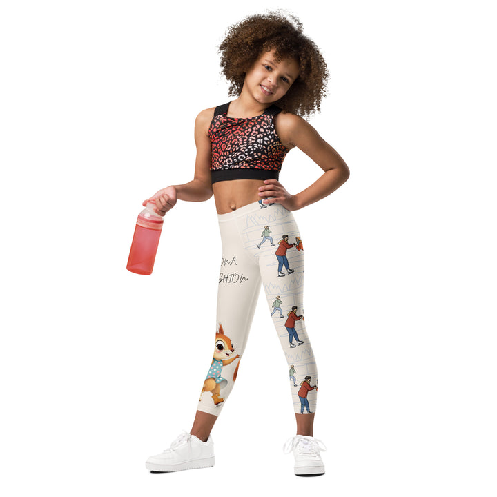  Frosty Twirl Squirrel Girls Leggings, beige background with a brown squirrel ice skating in a blue polka dot dress on one leg, ice trail lines, mountains, and small ice skaters along the other leg, in blue, brown, and orange tones, relaxed front pose on model-with a visible 'Leona Fashion' text on the design