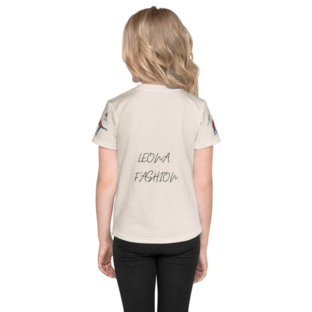 Frosty Twirl Squirrel Girls T-shirt, beige background with a brown squirrel ice skating in a blue polka dot dress on the front, ice trail lines on the sleeves, mountains and ice skaters on the back, in blue, brown, and orange tones, back view on model-with a visible 'Leona Fashion' text on the design