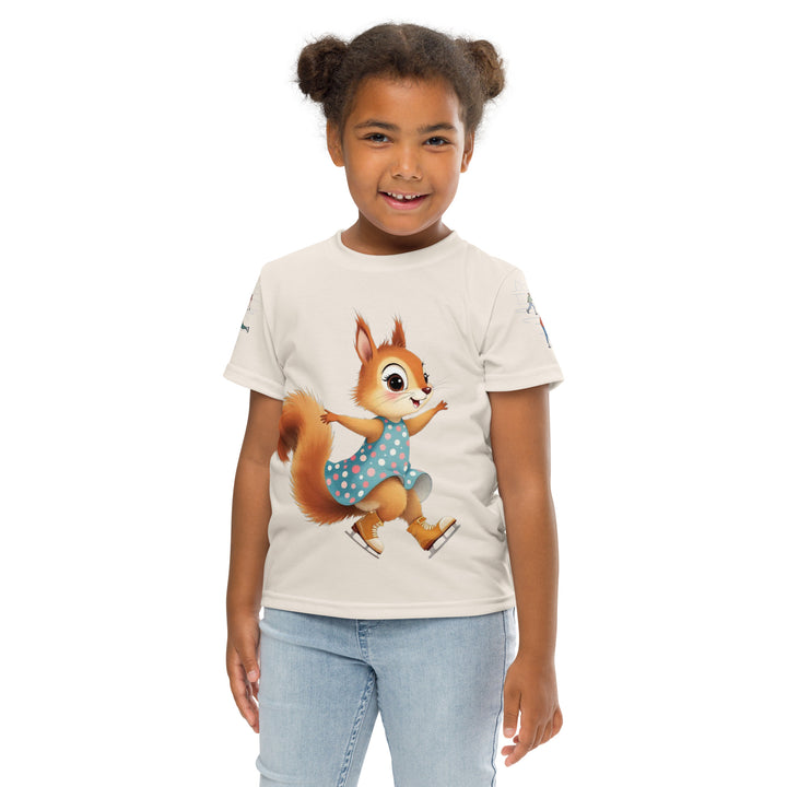 Frosty Twirl Squirrel Girls T-shirt, beige background with a brown squirrel ice skating in a blue polka dot dress on the front, ice trail lines on the sleeves, mountains and ice skaters on the back, in blue, brown, and orange tones, front pose with arms at sides on model-with a visible 'Leona Fashion' text on the design