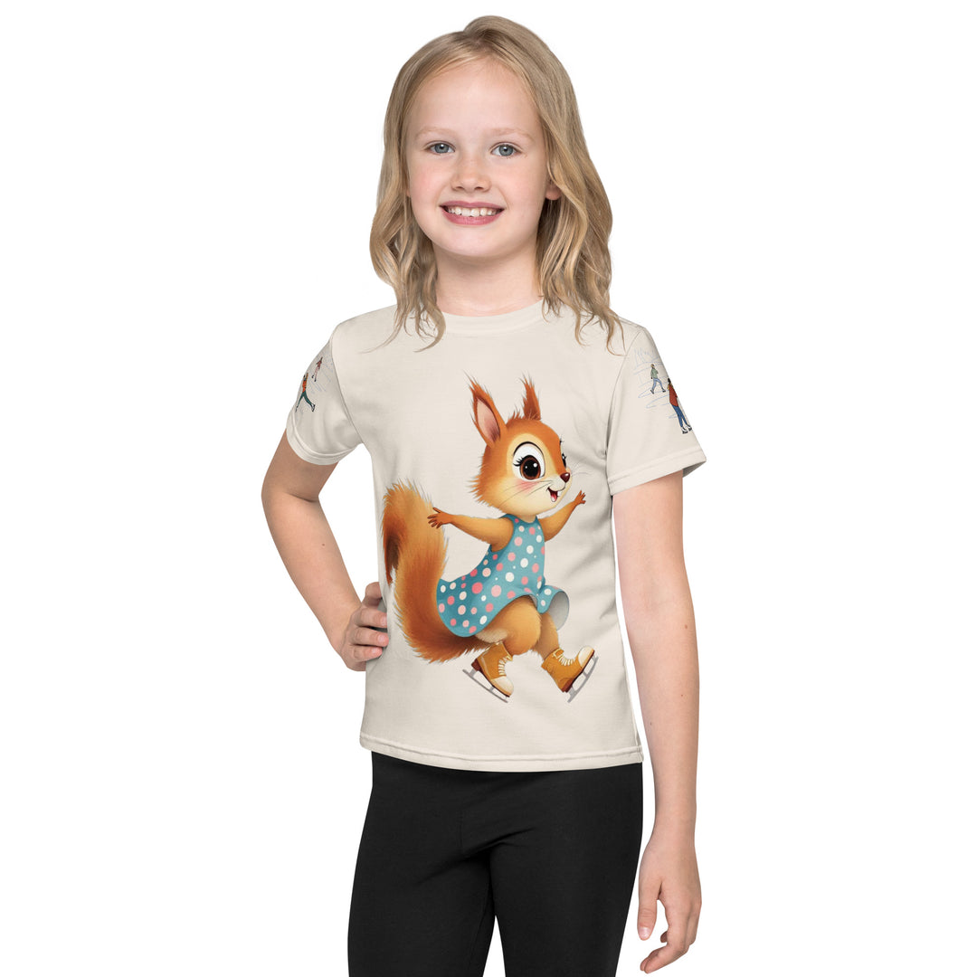 Frosty Twirl Squirrel Girls T-shirt, beige background with a brown squirrel ice skating in a blue polka dot dress on the front, ice trail lines on the sleeves, mountains and ice skaters on the back, in blue, brown, and orange tones, front view on model-with a visible 'Leona Fashion' text on the design