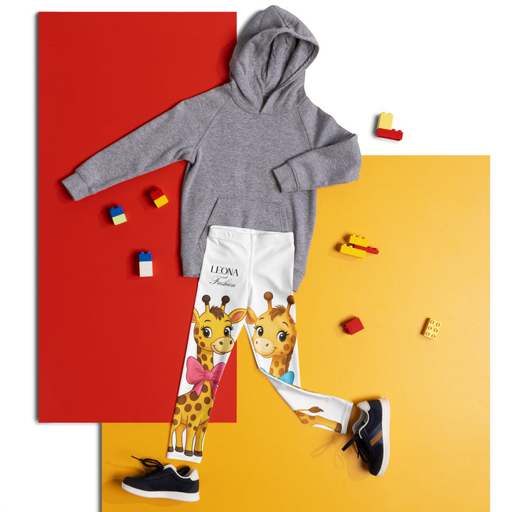 Giraffe Love Girls Leggings, white background with a full-length girl giraffe wearing a big pink bow around her neck on one leg, and a full-length boy giraffe with a blue bow around his neck on the other leg, front view laid flat on floor