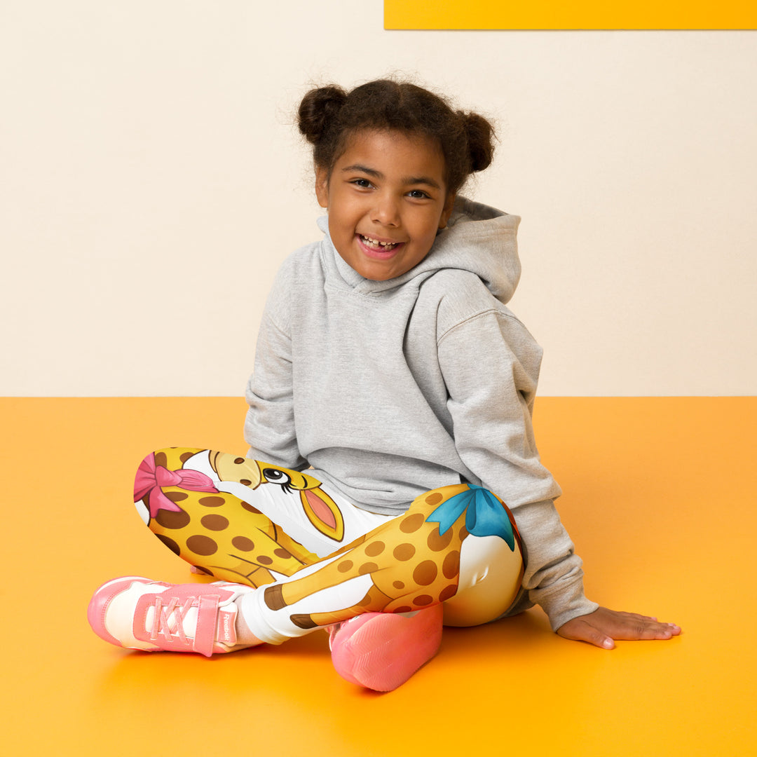 Giraffe Love Girls Leggings, white background with a full-length girl giraffe wearing a big pink bow around her neck on one leg, and a full-length boy giraffe with a blue bow around his neck on the other leg, seated pose on model