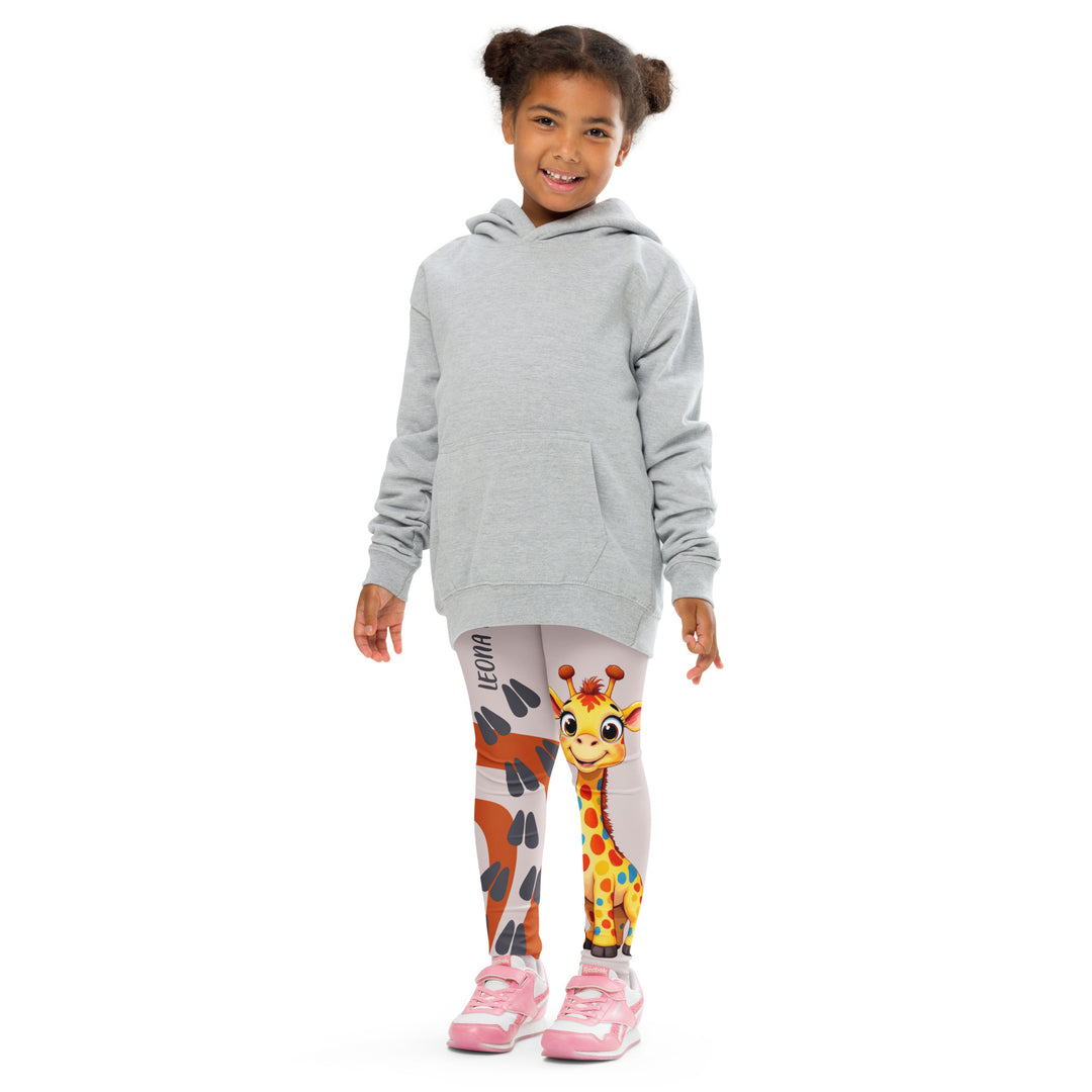 Giraffe Path Girls Leggings, cream background with a yellow giraffe featuring colorful polka dots on one leg, and orange-brown spots with dark gray giraffe footprints on the other leg, both designs starting from above the knee down, front pose with arms at sides on model