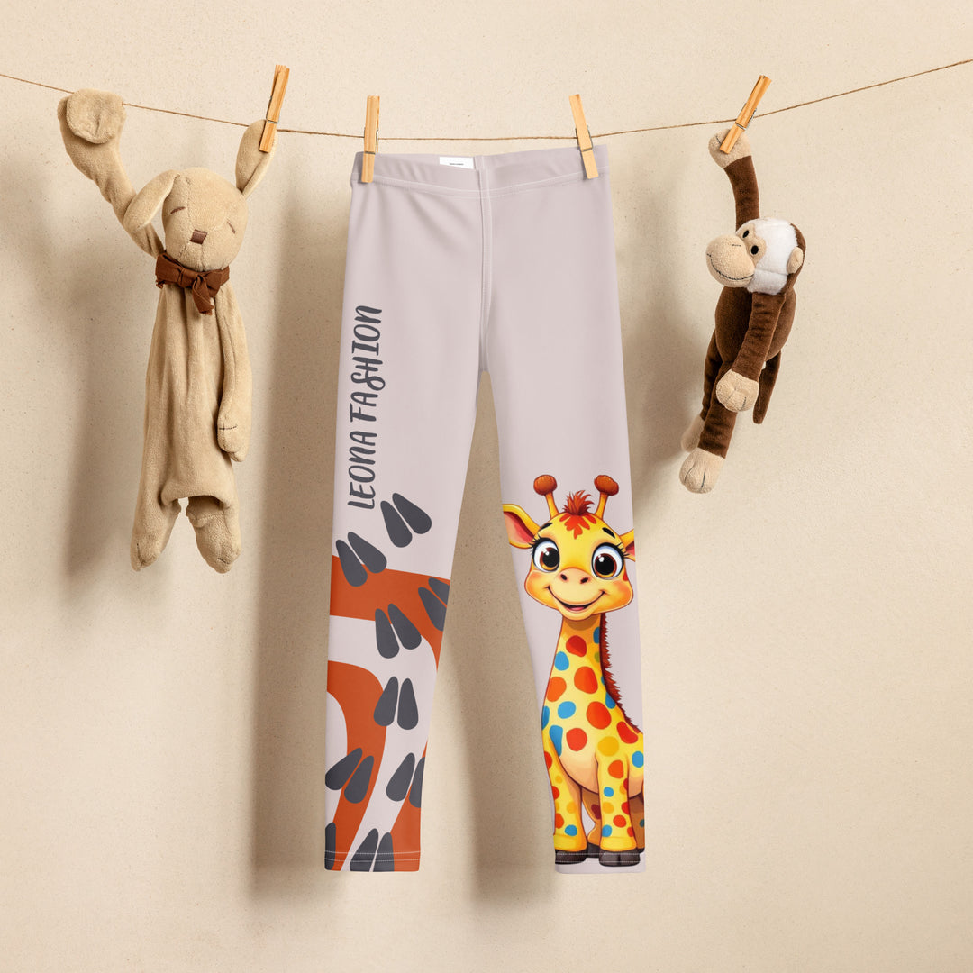 Giraffe Path Girls Leggings, cream background with a yellow giraffe featuring colorful polka dots on one leg, and orange-brown spots with dark gray giraffe footprints on the other leg, both designs starting from above the knee down, front view on hanger-with a visible 'Leona Fashion' text on the design