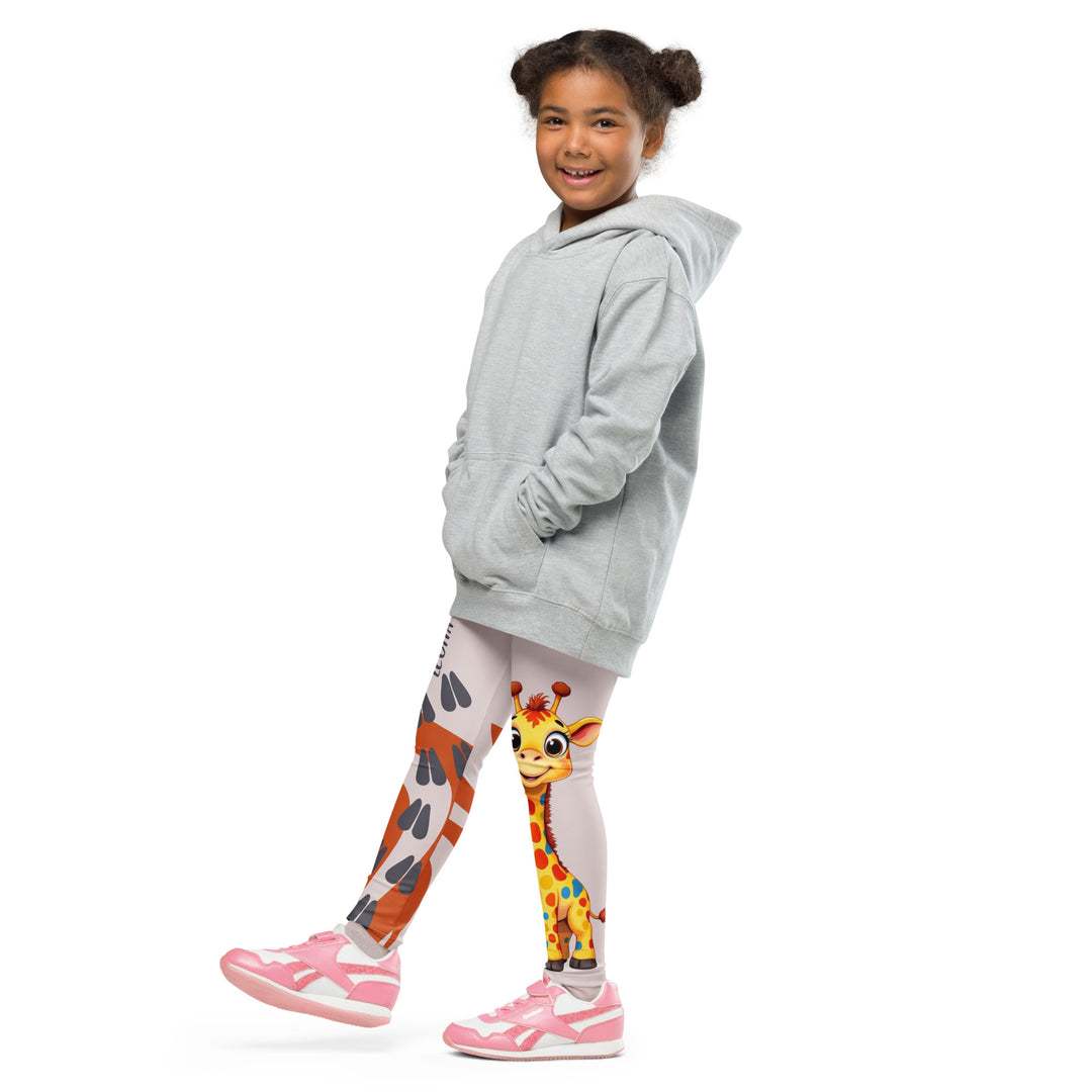 Giraffe Path Girls Leggings, cream background with a yellow giraffe featuring colorful polka dots on one leg, and orange-brown spots with dark gray giraffe footprints on the other leg, both designs starting from above the knee down, side view with one leg lifted and extended on model