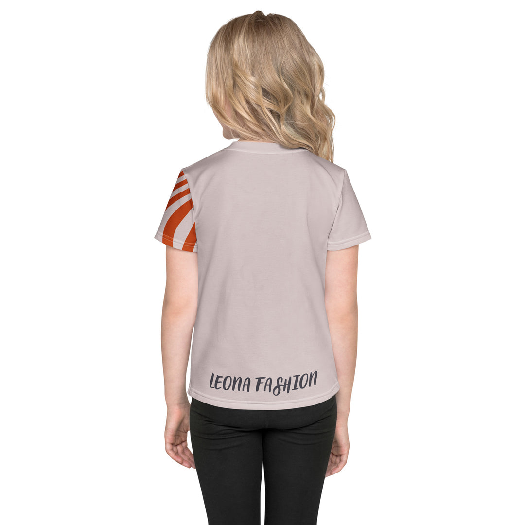 Giraffe Path Girls T-shirt, cream background with a smiling yellow giraffe featuring colorful polka dots on the front, dark gray giraffe paw prints behind, and brown-orange wavy lines on the left sleeve, back view on model-with a visible 'Leona Fashion' text on the design