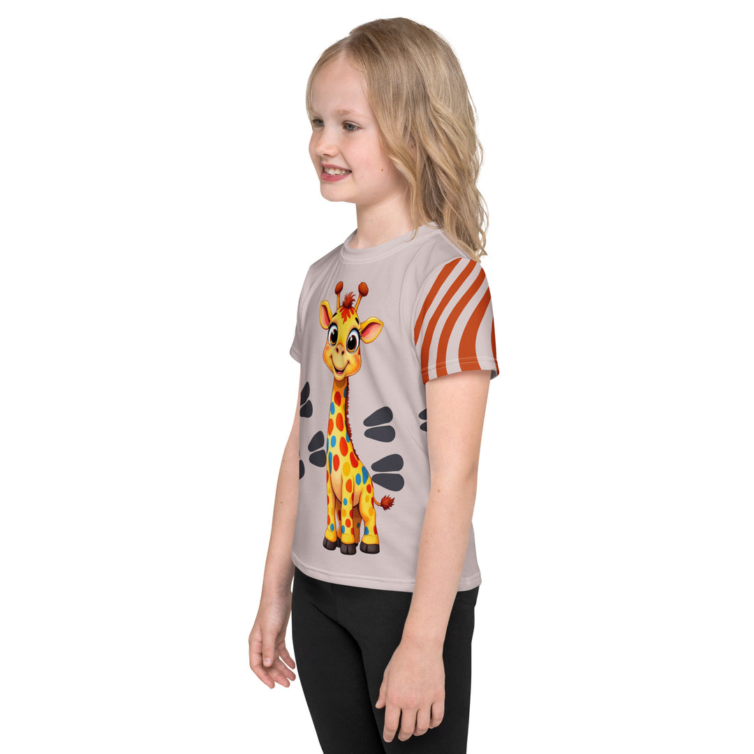  Giraffe Path Girls T-shirt, cream background with a smiling yellow giraffe featuring colorful polka dots on the front, dark gray giraffe paw prints behind, and brown-orange wavy lines on the left sleeve, left side view on model