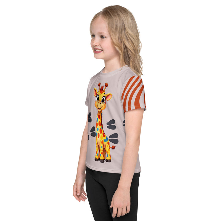  Giraffe Path Girls T-shirt, cream background with a smiling yellow giraffe featuring colorful polka dots on the front, dark gray giraffe paw prints behind, and brown-orange wavy lines on the left sleeve, left side view on model
