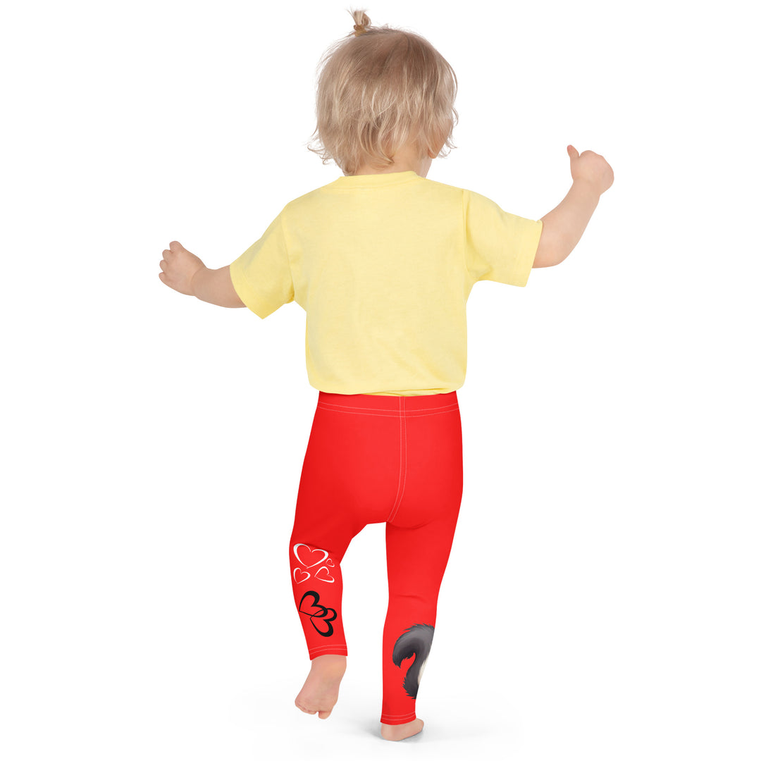 Heart Stinker Girls Leggings, red background with a black and white skunk holding a white flower in its hand, featuring white hearts and pink-and-white floral elements, back pose on model