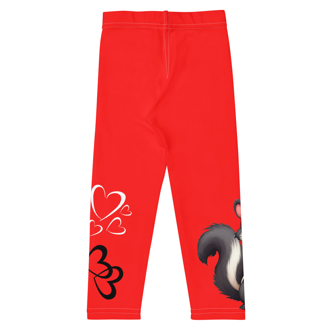Heart Stinker Girls Leggings, red background with a black and white skunk holding a white flower in its hand, featuring white hearts and pink-and-white floral elements, back view