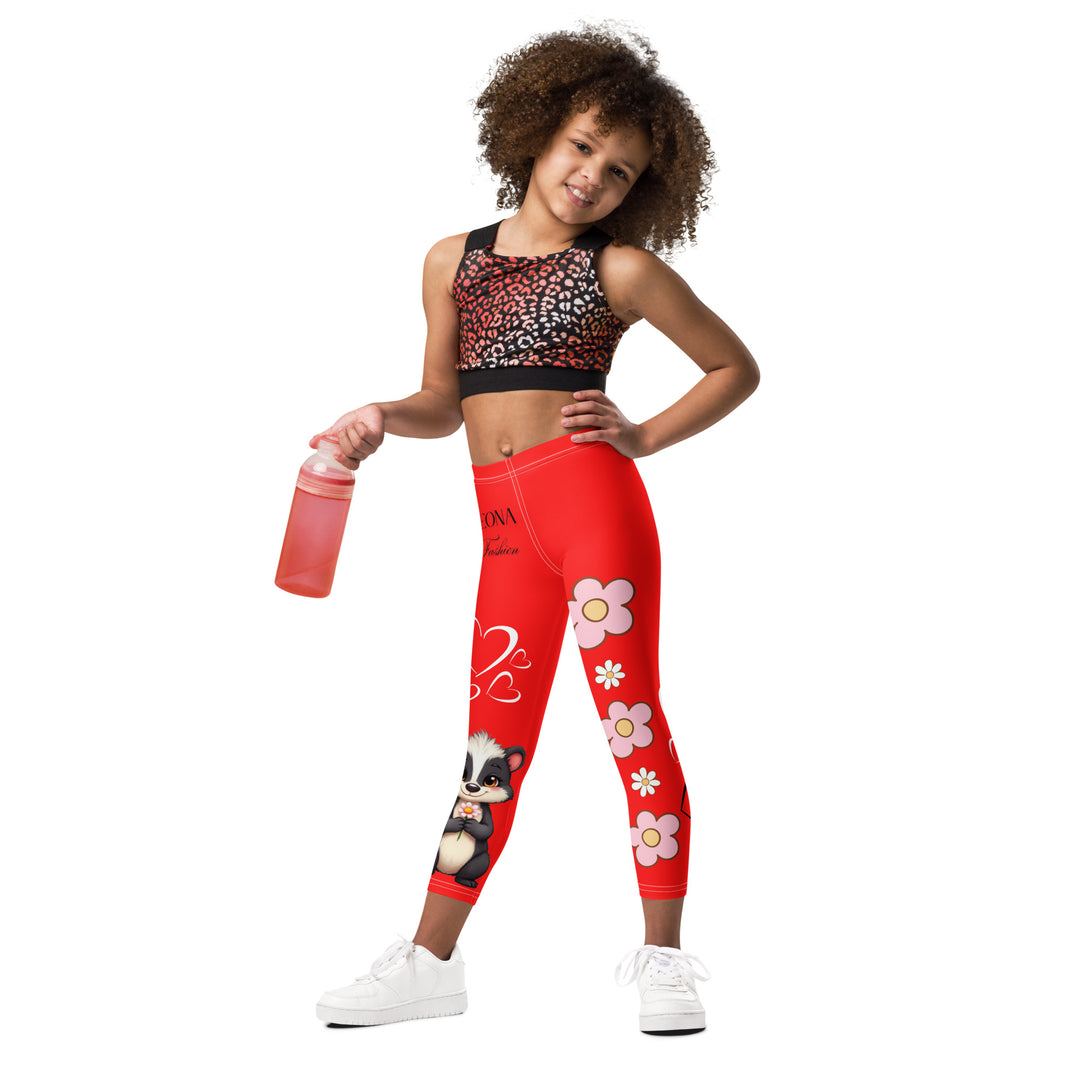 Heart Stinker Girls Leggings, red background with a black and white skunk holding a white flower in its hand, featuring white hearts and pink-and-white floral elements, front view on model-with a visible 'Leona Fashion' text on the design