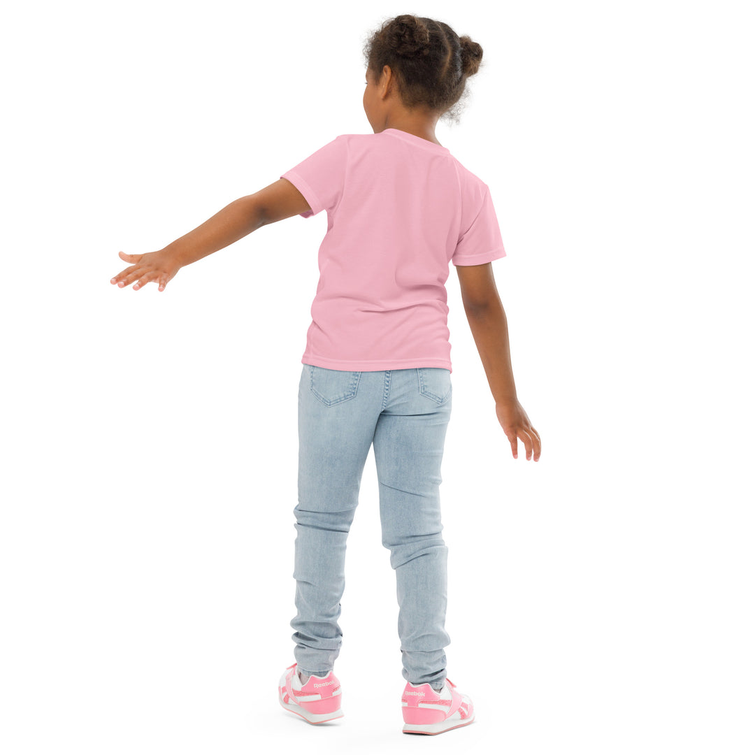 Jungle Parrot Girls T-shirt, light pink background with a red, yellow, orange, and green parrot standing on a branch on the front, back pose on model