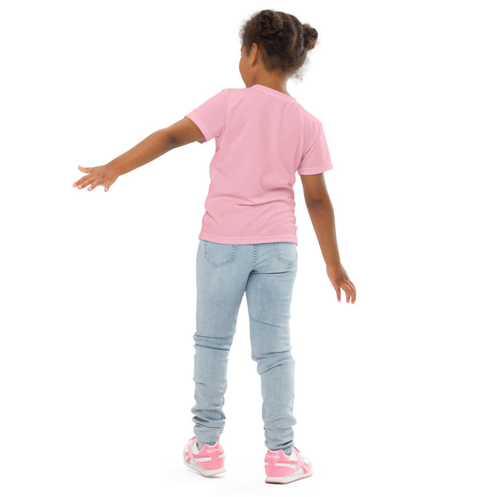 Jungle Parrot Girls T-shirt, light pink background with a red, yellow, orange, and green parrot standing on a branch on the front, back pose on model