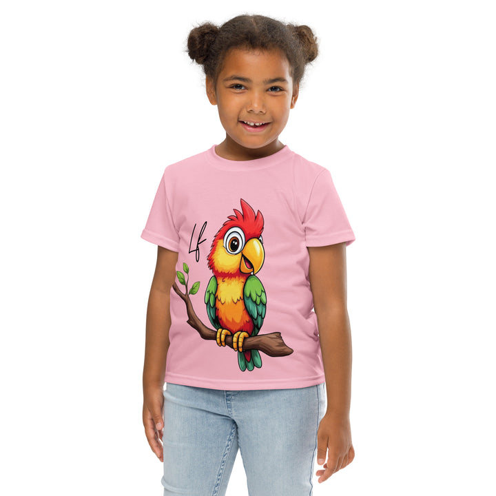 Jungle Parrot Girls T-shirt, light pink background with a red, yellow, orange, and green parrot standing on a branch on the front, front pose with arms at sides on model