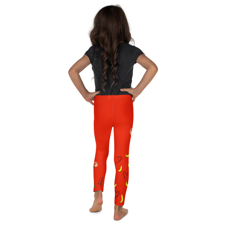 Love Monkey Girls Leggings, red background with a smiling female monkey with big eyes and a pink bow on the head at the top of one leg, yellow bananas with black drawn hearts below, and a winking male monkey wearing a hat sitting on a tree stump near the bottom of the other leg, with the word "LOVE" above, back view on model
