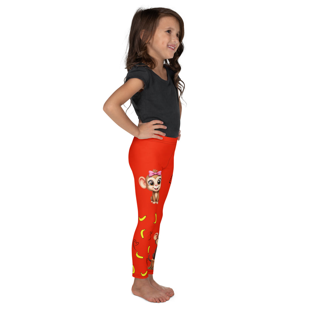  Love Monkey Girls Leggings, red background with a smiling female monkey with big eyes and a pink bow on the head at the top of one leg, yellow bananas with black drawn hearts below, and a winking male monkey wearing a hat sitting on a tree stump near the bottom of the other leg, with the word "LOVE" above, right side view on model