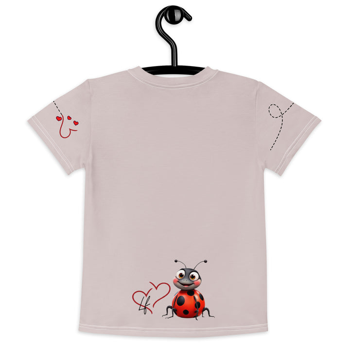 Lovebugs Girls T-shirt, sand-colored background with a smiling female ladybug with big eyes on the front, a happy male ladybug with a heart beside him on the back, and hearts with connecting lines on both sleeves, back view on hanger
