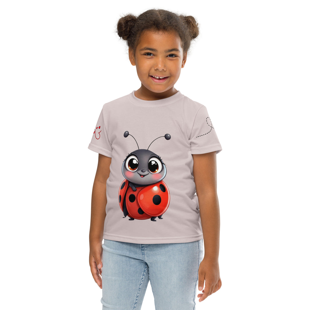  Lovebugs Girls T-shirt, sand-colored background with a smiling female ladybug with big eyes on the front, a happy male ladybug with a heart beside him on the back, and hearts with connecting lines on both sleeves, front pose with arms at sides on model