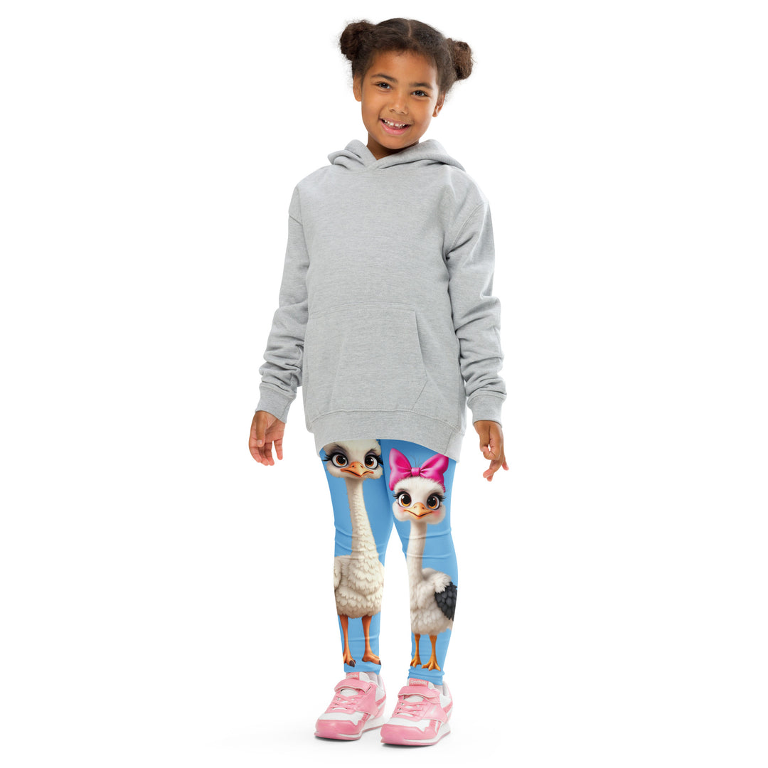 Mama & Me Ostrich Girls Leggings, sky blue background with a large white mother ostrich wearing a pink bow on her head on one leg, "MOM" text in black and pink above, and a smaller white daughter ostrich with black wings and a pink bow on her head on the other leg, front pose with arms at sides on model