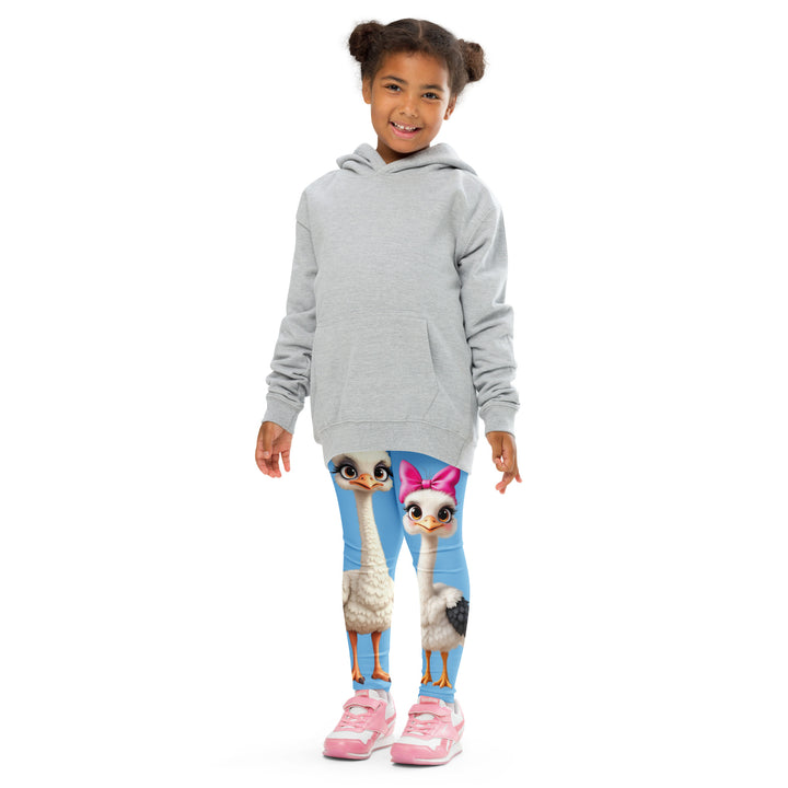 Mama & Me Ostrich Girls Leggings, sky blue background with a large white mother ostrich wearing a pink bow on her head on one leg, "MOM" text in black and pink above, and a smaller white daughter ostrich with black wings and a pink bow on her head on the other leg, front pose with arms at sides on model