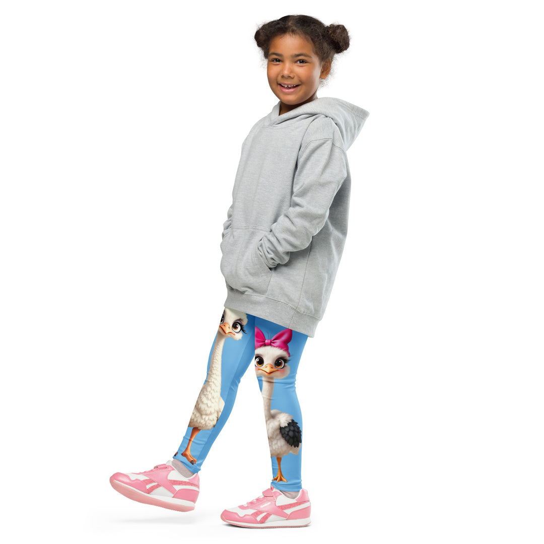 Mama & Me Ostrich Girls Leggings, sky blue background with a large white mother ostrich wearing a pink bow on her head on one leg, "MOM" text in black and pink above, and a smaller white daughter ostrich with black wings and a pink bow on her head on the other leg, side view with one leg lifted and extended on model