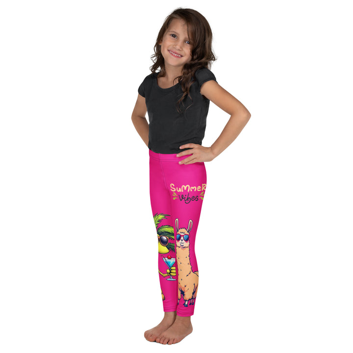 Palma Llama Girls Leggings, pink background with a palm tree wearing sunglasses and holding a cocktail on one leg, and a llama with sunglasses and "SUMMER VIBES" text above on the other leg, designs covering almost the full length of each leg, left side view on model