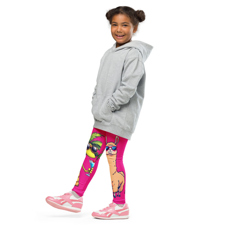 Palma Llama Girls Leggings, pink background with a palm tree wearing sunglasses and holding a cocktail on one leg, and a llama with sunglasses and "SUMMER VIBES" text above on the other leg, designs covering almost the full length of each leg, side view with one leg lifted and extended on model