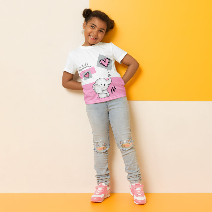 Pastel Elephant Love Girls T-shirt, white background with gray elephant holding a pink balloon, and a second pink balloon floating next to it, surrounded by pink hearts and pink and gray rectangles, relaxed front pose on model-with a visible 'Leona Fashion' text on the design