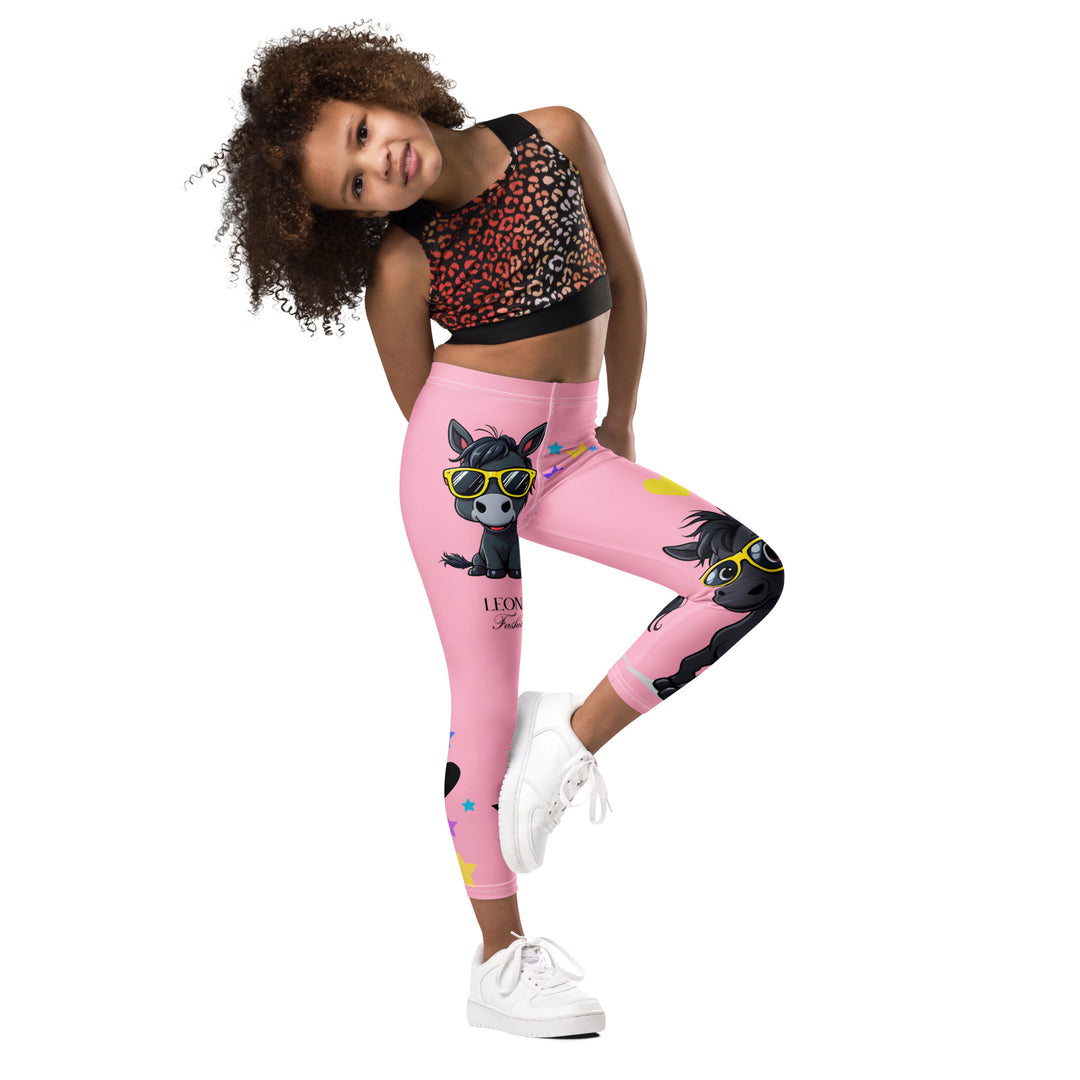 Pony Cool Girls Leggings, pink background with two black ponies wearing sunglasses and star details, rear side view with one leg bent shown on model-with a visible 'Leona Fashion' text on the design