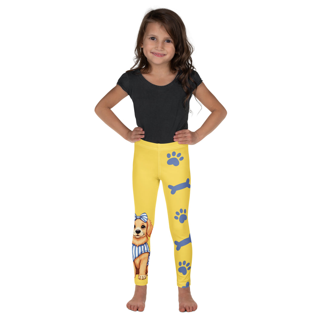Puppy & Bones Girls Leggings, yellow background with a golden retriever puppy wearing a blue and white striped outfit and a matching blue and white bow on the head on one leg, and blue paw prints and blue bones running down the other leg, front view on model