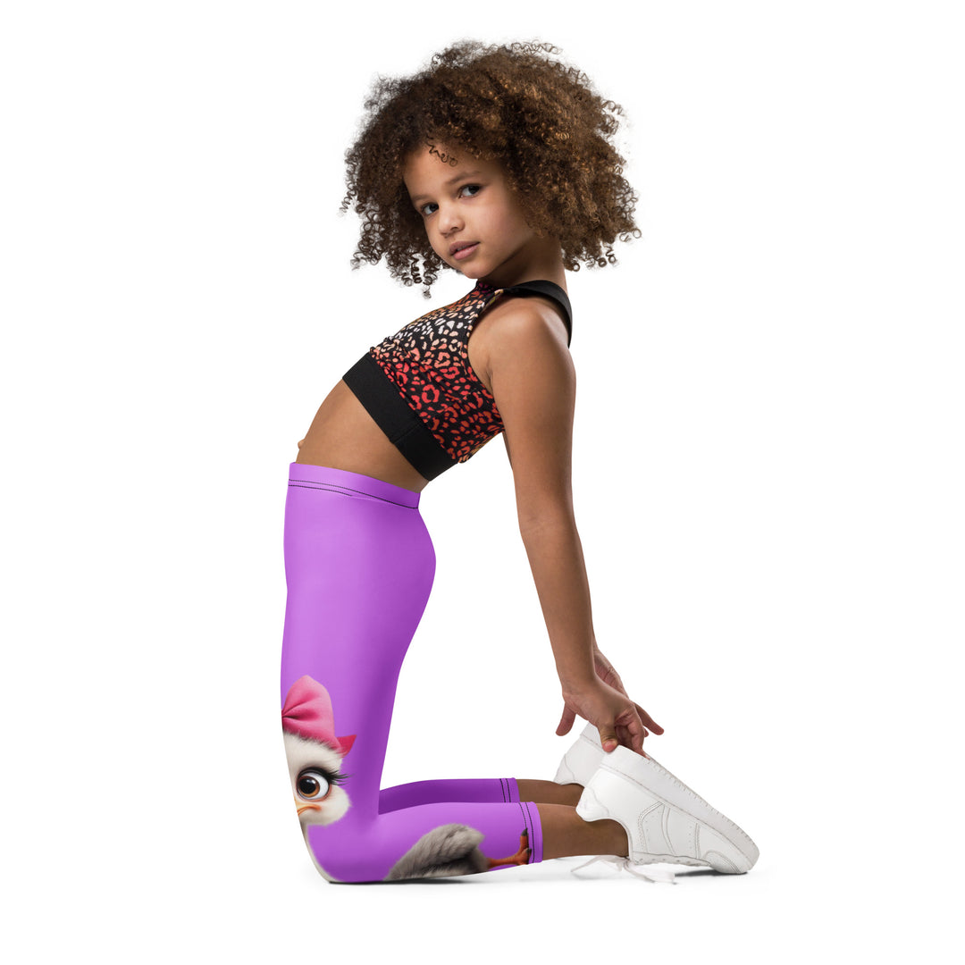  Purple Baby Ostrich Girls Leggings, purple background with a white and gray baby ostrich girl featuring a pink bow on her head extending almost the full length of one leg, left side view kneeling on model