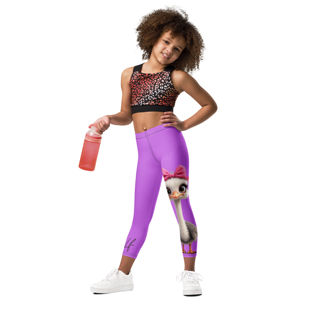 Purple Baby Ostrich Girls Leggings, purple background with a white and gray baby ostrich girl featuring a pink bow on her head extending almost the full length of one leg, relaxed front pose on model