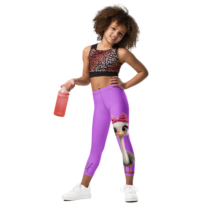 Purple Baby Ostrich Girls Leggings, purple background with a white and gray baby ostrich girl featuring a pink bow on her head extending almost the full length of one leg, relaxed front pose on model