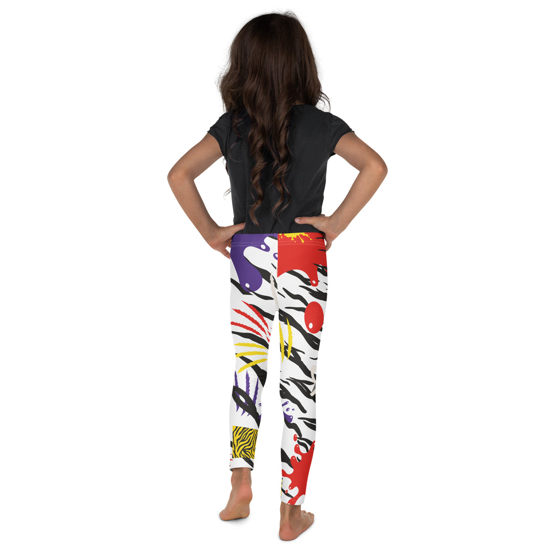 Raccoon Bandit Glow Girls Leggings, white base with splash-like spots in red, purple, and yellow, gray raccoon head, and wavy black stripes, back view on model