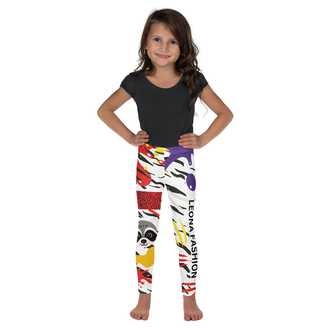 Raccoon Bandit Glow Girls Leggings, white base with splash-like spots in red, purple, and yellow, gray raccoon head, and wavy black stripes, front pose with hands on hips on model-with a visible 'Leona Fashion' text on the design