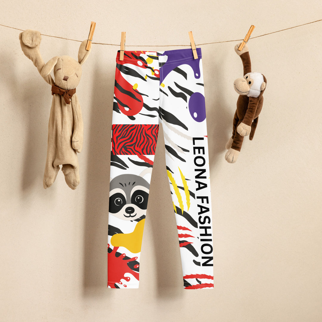 Raccoon Bandit Glow Girls Leggings, white base with splash-like spots in red, purple, and yellow, gray raccoon head, and wavy black stripes, front view on hanger-with a visible 'Leona Fashion' text on the design