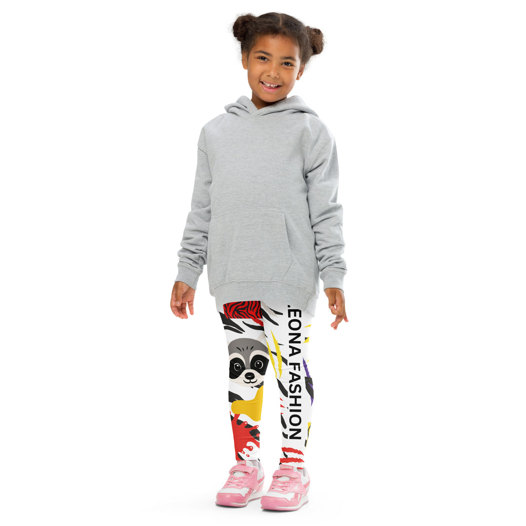Raccoon Bandit Glow Girls Leggings, white base with splash-like spots in red, purple, and yellow, gray raccoon head, and wavy black stripes, front pose with arms extended on model-with a visible 'Leona Fashion' text on the design