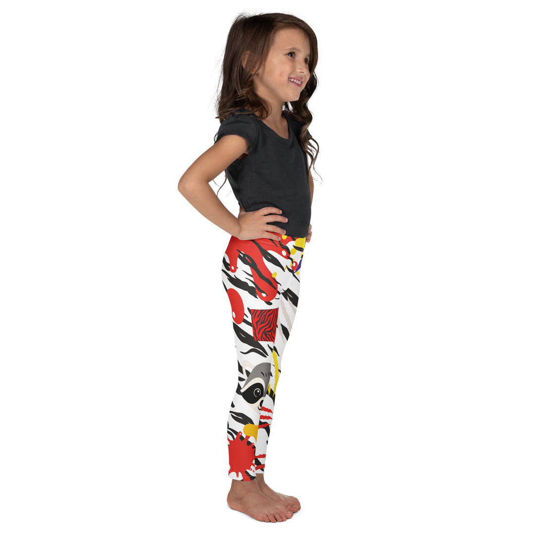 Raccoon Bandit Glow Girls Leggings, white base with splash-like spots in red, purple, and yellow, gray raccoon head, and wavy black stripes, right side view on model