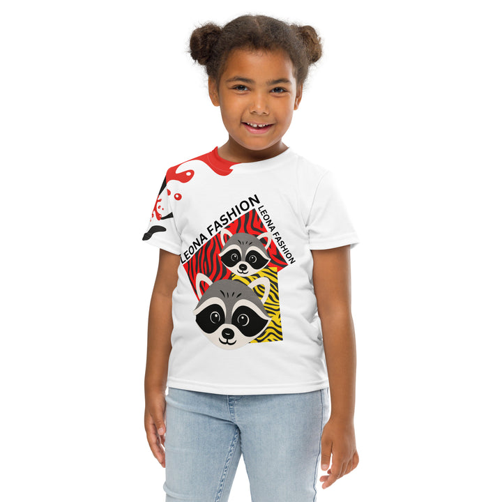 Raccoon Bandit Glow Girls T-shirt, white background with two gray raccoons inside red and yellow rectangular patterns with black stripes, red and black splash detail on right sleeve and neckline, front pose with arms at sides on model-with a visible 'Leona Fashion' text on the design