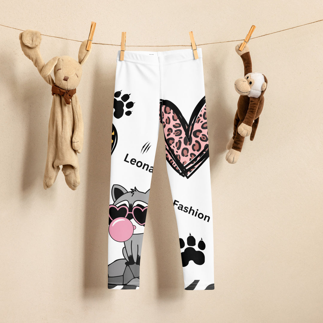  Raccoon Love Girls Leggings, white background with gray raccoon blowing a pink bubble gum sitting on a rock, pink tiger-striped heart, claws, and animal paw details, front view on display clips-with a visible 'Leona Fashion' text on the design