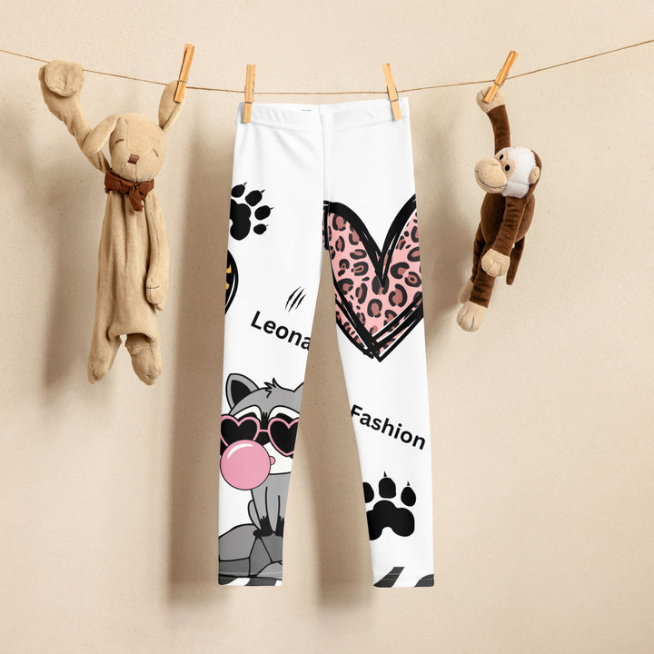  Raccoon Love Girls Leggings, white background with gray raccoon blowing a pink bubble gum sitting on a rock, pink tiger-striped heart, claws, and animal paw details, front view on display clips-with a visible 'Leona Fashion' text on the design