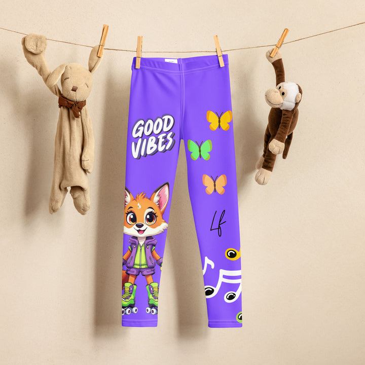Roller Fox Girls Leggings, purple background with an orange fox wearing purple and neon green sportswear and neon green roller skates on one leg, "GOOD VIBES" text in white above, and orange-green butterflies and orange, green, and white music notes on the other leg, front view on hanger