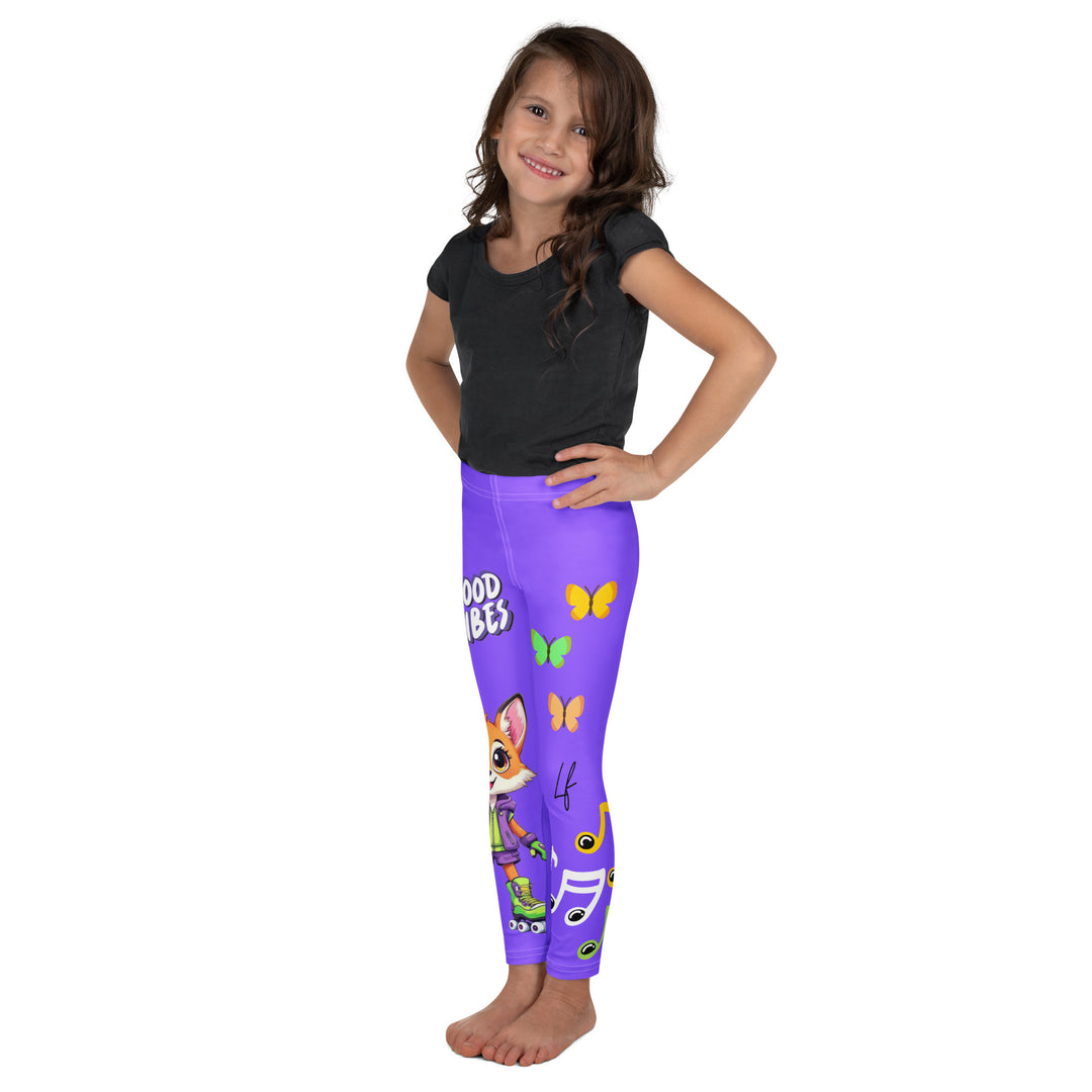 Roller Fox Girls Leggings, purple background with an orange fox wearing purple and neon green sportswear and neon green roller skates on one leg, "GOOD VIBES" text in white above, and orange-green butterflies and orange, green, and white music notes on the other leg, left side view on model