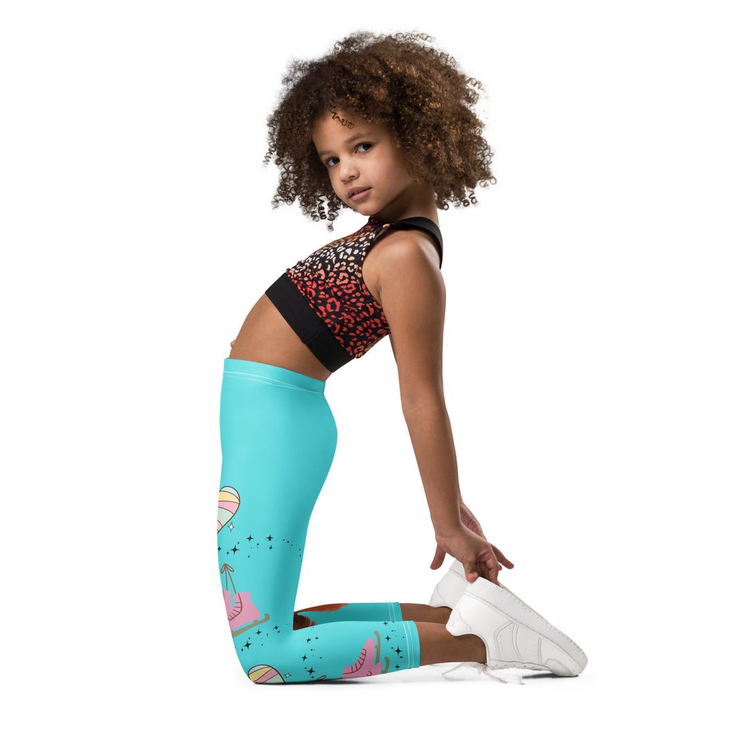 Skate Squirrel Girls Leggings, pastel blue background with a squirrel wearing a pink dress and ice skates on one leg, pastel pink and blue hearts with pink skates on the other leg, and black sparkling star details winding between the elements, left side view kneeling on model