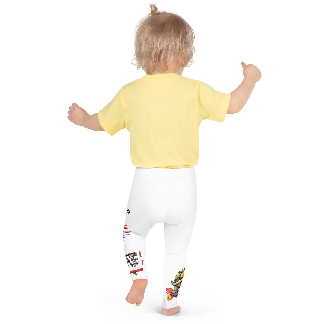 Skater Turtle Girls Leggings, white background with a green turtle riding a skateboard on one leg, black "MAKE YOUR MOVE" text and black skater silhouette with pink and purple motion lines on the other leg, and a skateboard with "skate" text at the bottom of the leg, back pose on model