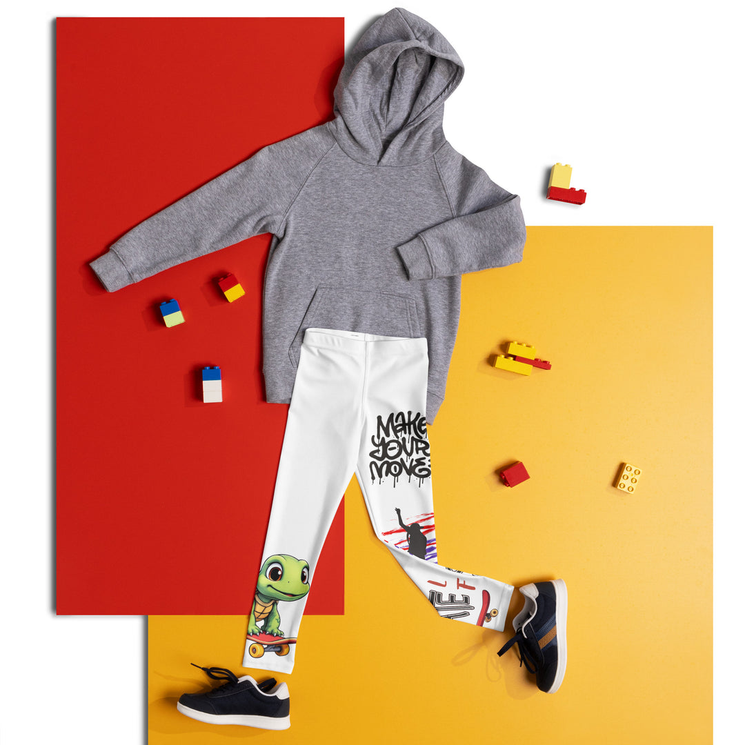  Skater Turtle Girls Leggings, white background with a green turtle riding a skateboard on one leg, black "MAKE YOUR MOVE" text and black skater silhouette with pink and purple motion lines on the other leg, and a skateboard with "skate" text at the bottom of the leg, front view laid flat on floor